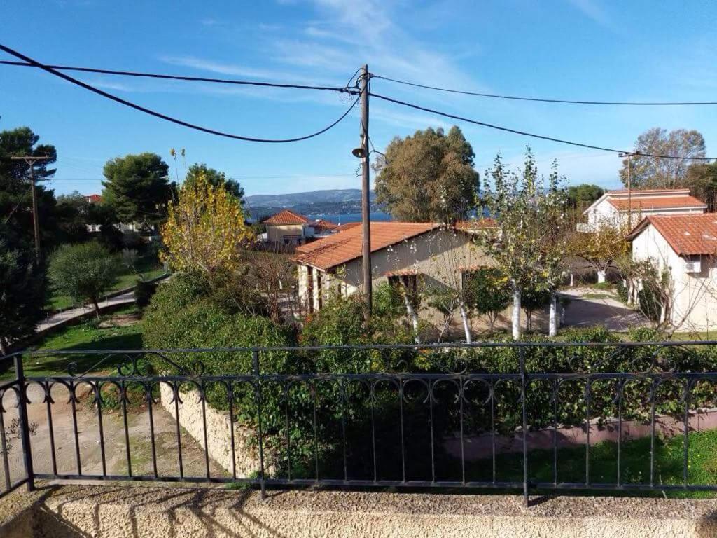 a view of a house from a fence at Yellow house in Lassi