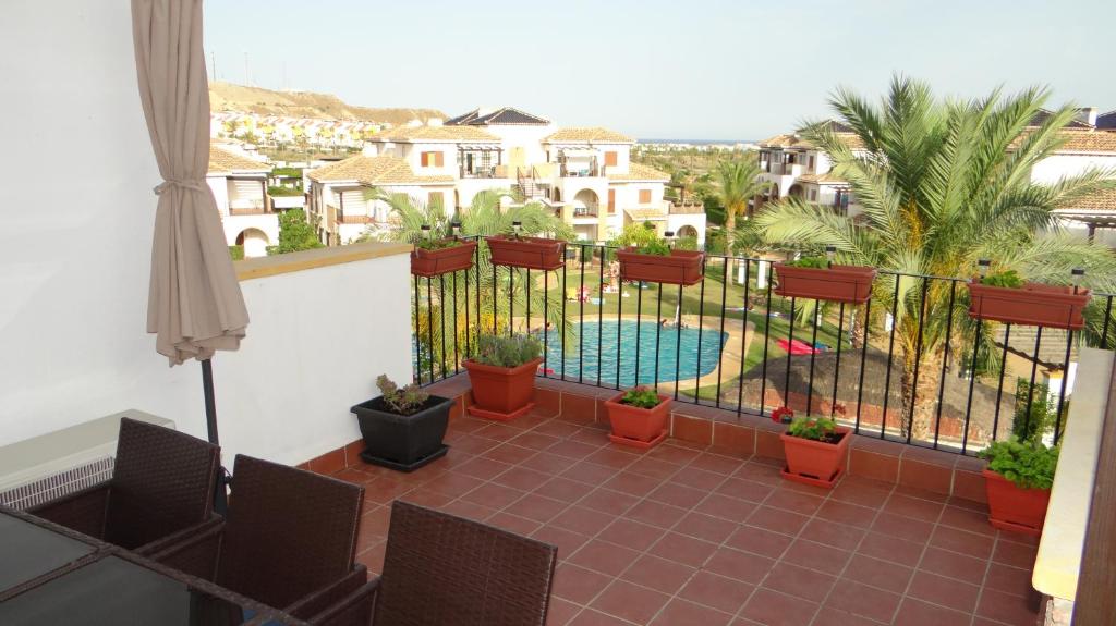 a balcony with a view of a swimming pool at Vera Rental Thalassa II in Vera