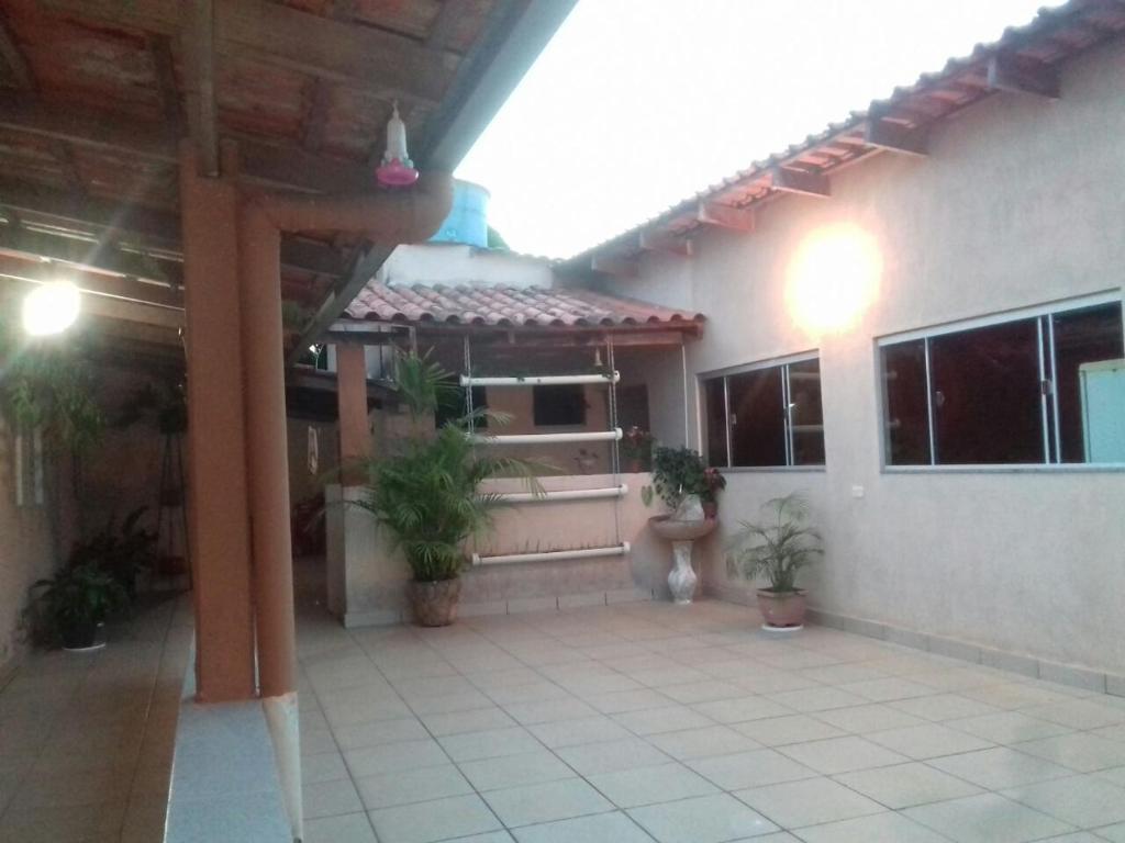 a patio of a house with potted plants at Pousada Serra Da Canastra in Vargem Bonita