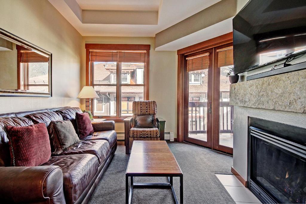 a living room with a couch and a fireplace at CO405 Copper One Lodge Condo in Copper Mountain