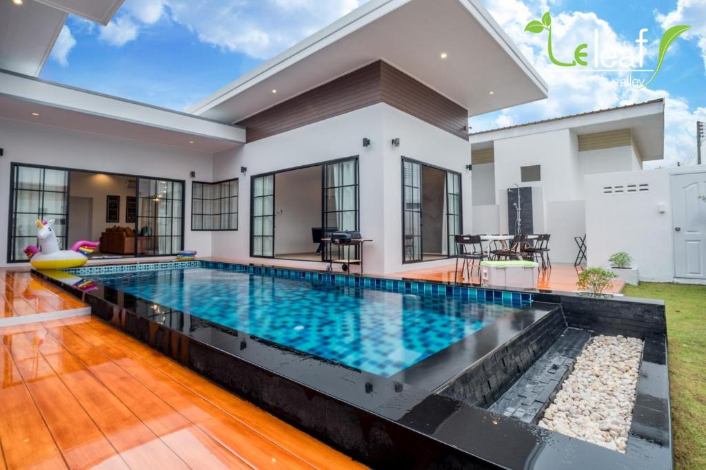 a swimming pool in the middle of a house at J Pool Villa Huahin in Hua Hin
