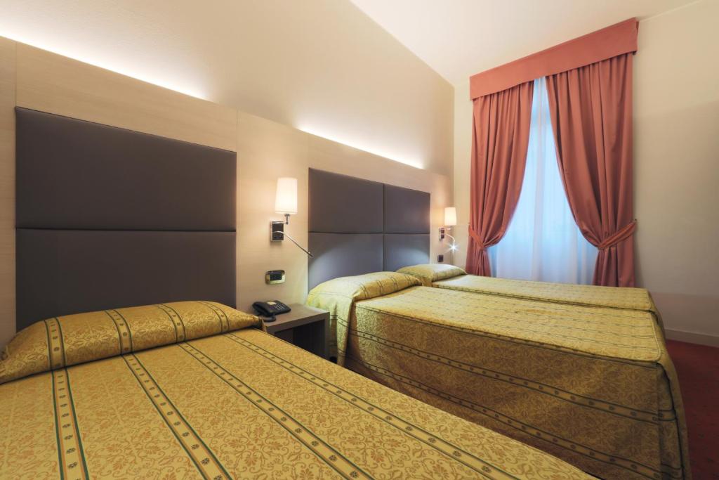Postel nebo postele na pokoji v ubytování Hotel Campion