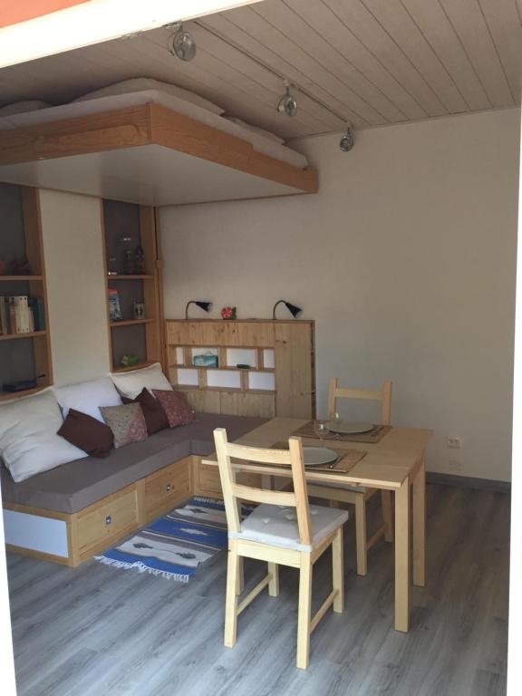 a bedroom with a bed and a table with a desk at Chez Régine et Serge in Bandol