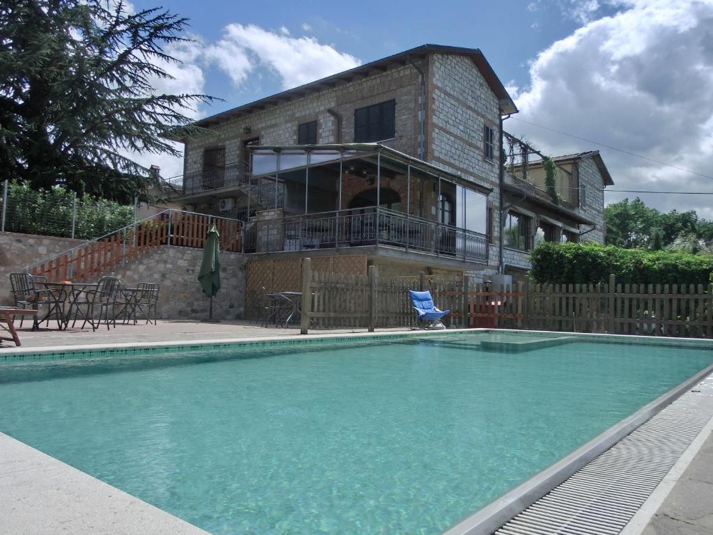 a house with a swimming pool in front of a house at Agriturismo La Pietriccia in Chianciano Terme