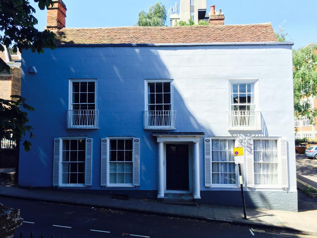 a blue house on a street at Baye House in Colchester