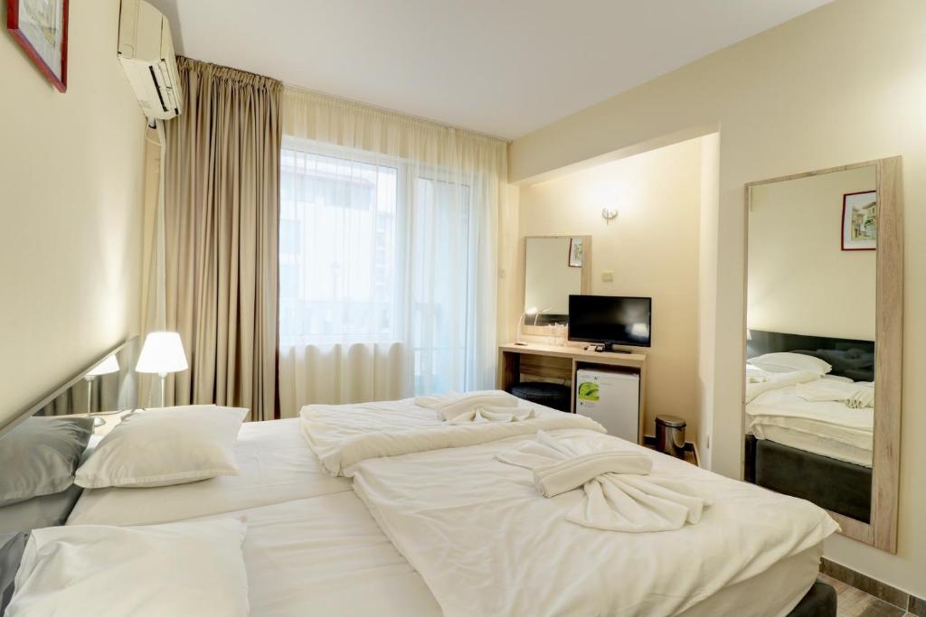 Postel nebo postele na pokoji v ubytování Family Hotel Jupiter