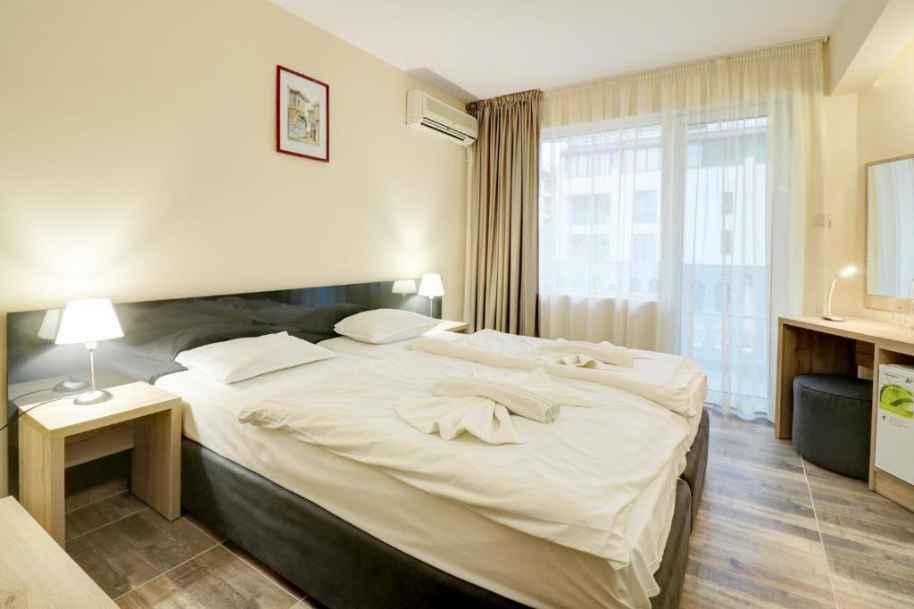 Postel nebo postele na pokoji v ubytování Family Hotel Jupiter
