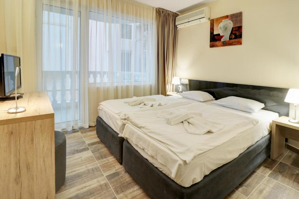 Postel nebo postele na pokoji v ubytování Family Hotel Jupiter
