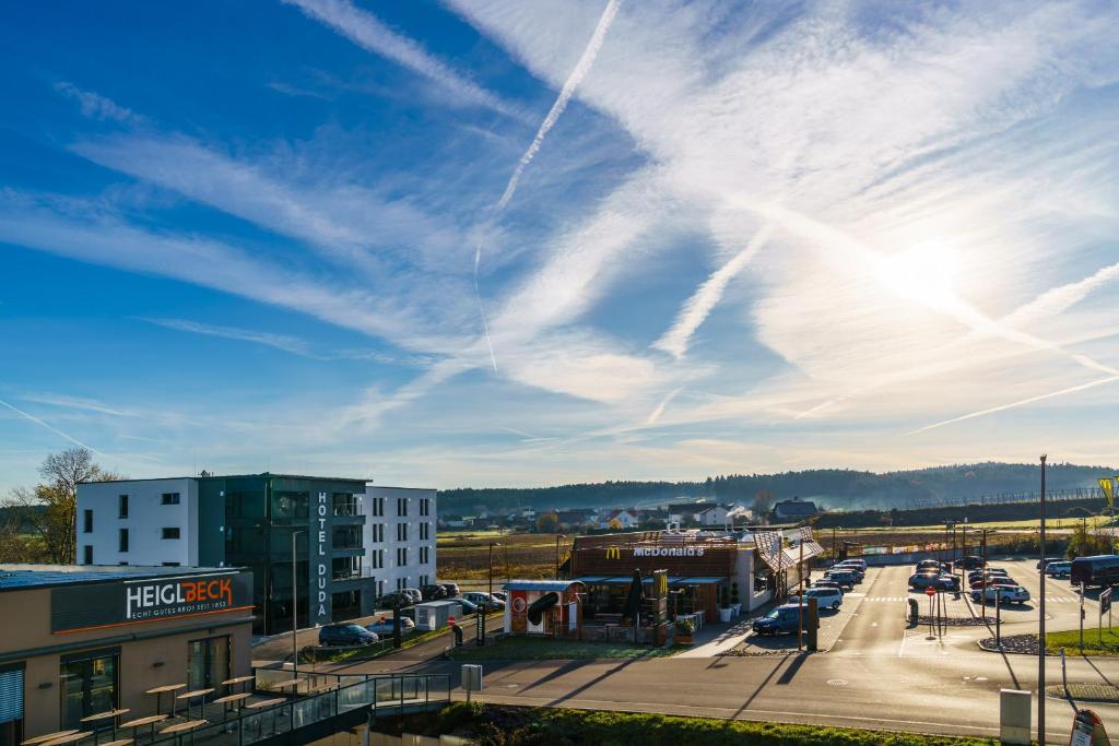 arial view of a city with a cloudy sky at Hotel Duda Boardingroom in Langenbruck