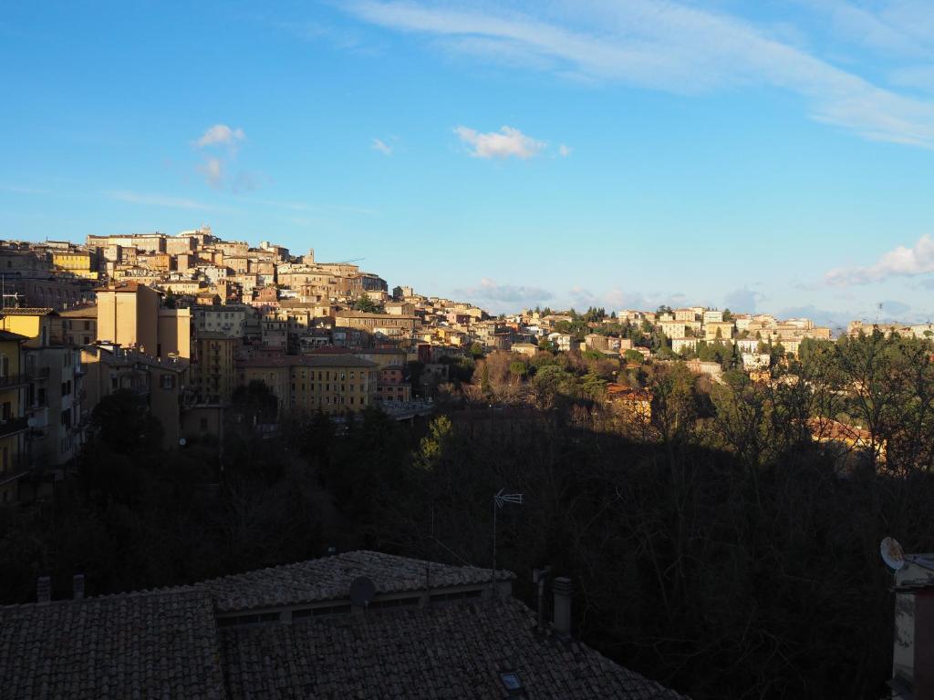a view of a city with buildings on a hill at trompe l'oeil in Perugia