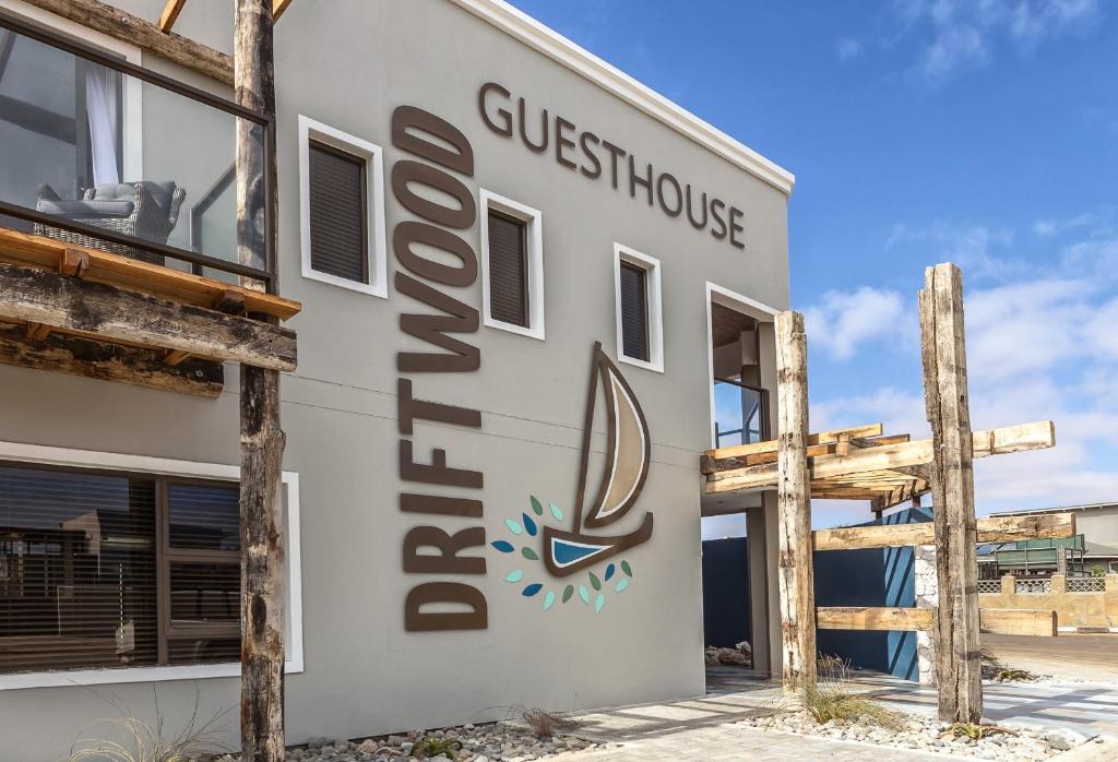 a building with the guesthouse sign on it at Driftwood Guesthouse in Swakopmund