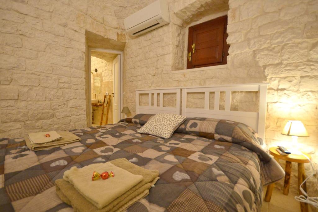 Postel nebo postele na pokoji v ubytování Trulli Petra Chiara