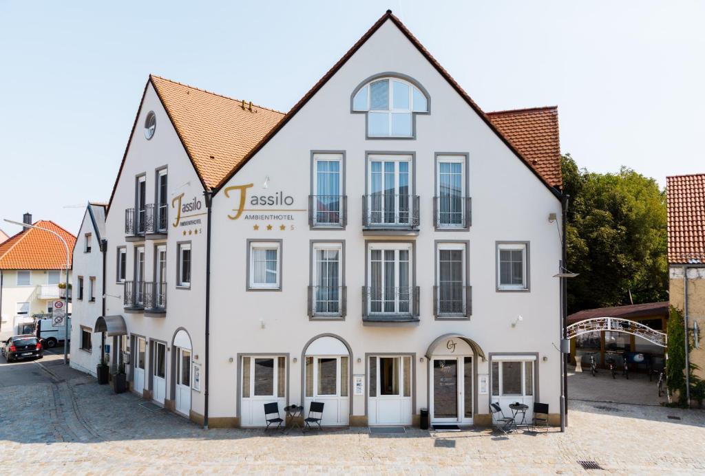 a large white building with a lot of windows at Ambienthotel Tassilo in Dingolfing