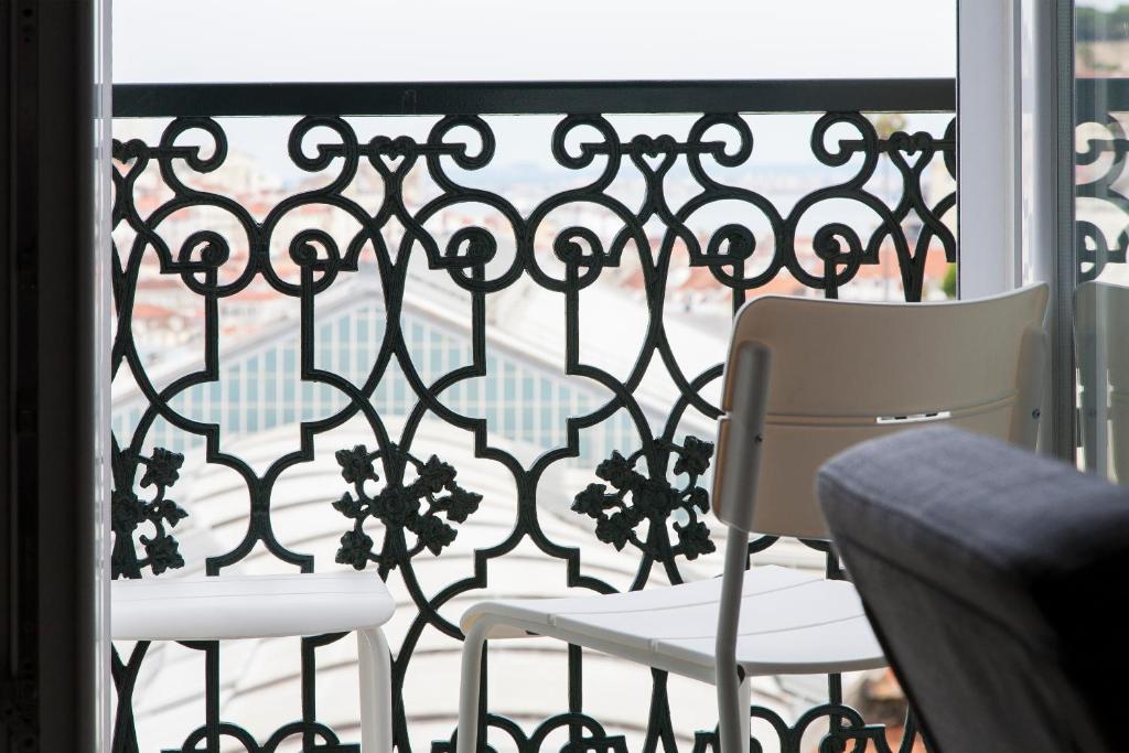 two chairs sitting on a balcony with a window at bairro alto view point 3 bedrooms chalet in Lisbon