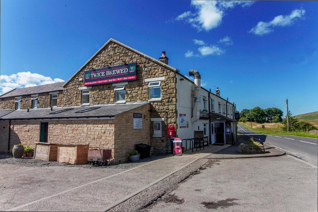 ein Gebäude am Straßenrand in der Unterkunft The Twice Brewed Inn in Bardon Mill