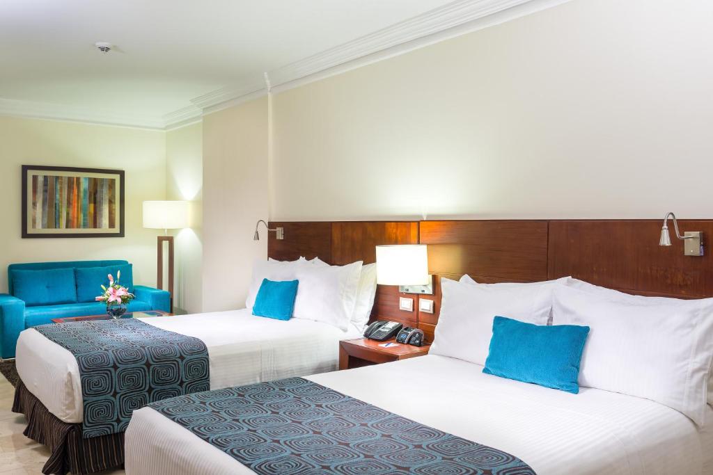 Una cama o camas en una habitación de Hotel Dann Carlton Bucaramanga