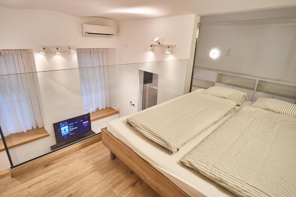Posteľ alebo postele v izbe v ubytovaní V27 Apartment | hostAID