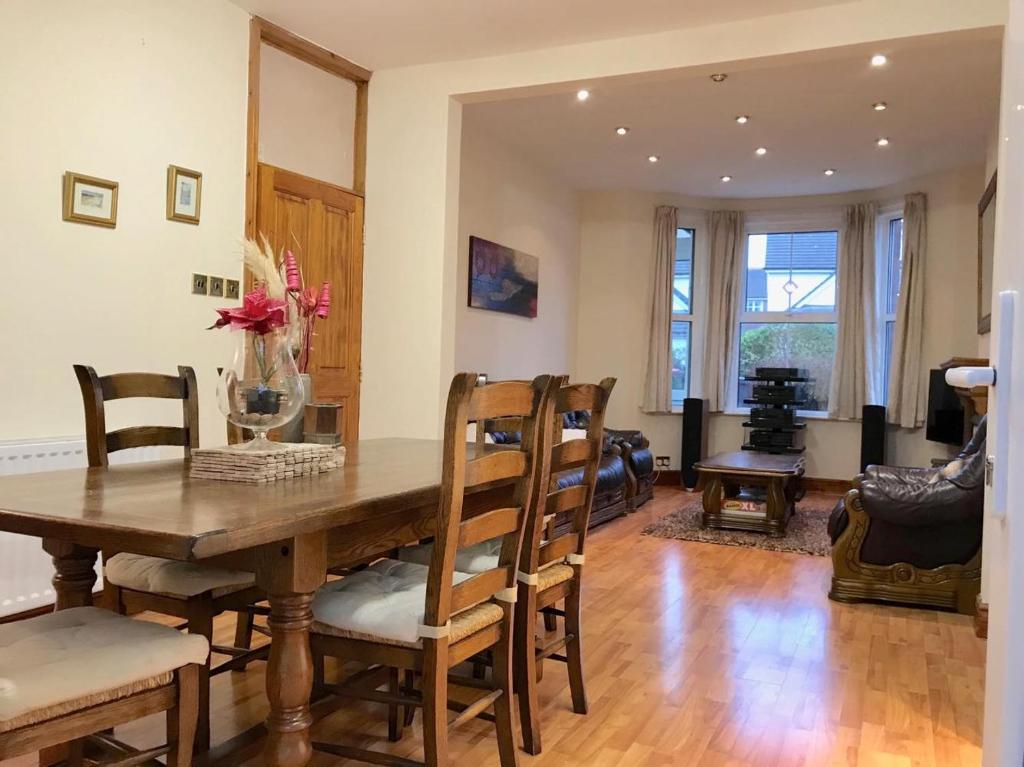 a dining room with a wooden table and chairs at Hamilton house in Exmouth