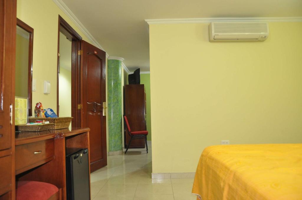 Postel nebo postele na pokoji v ubytování Hotel el Caimito