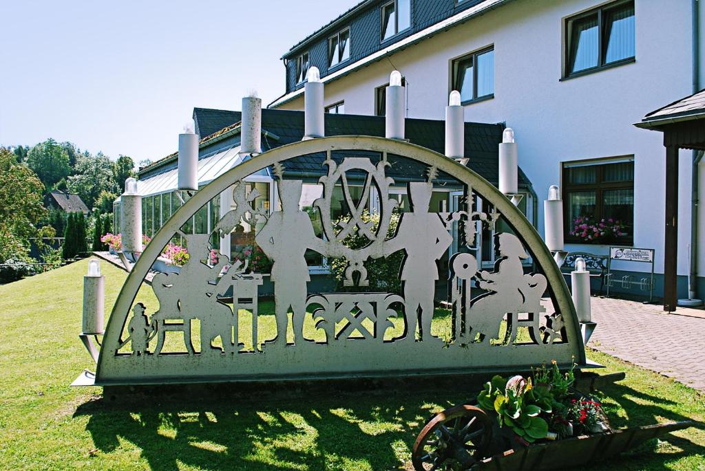 a gate in the grass in front of a building at Landgasthof-Wemmer in Großrückerswalde