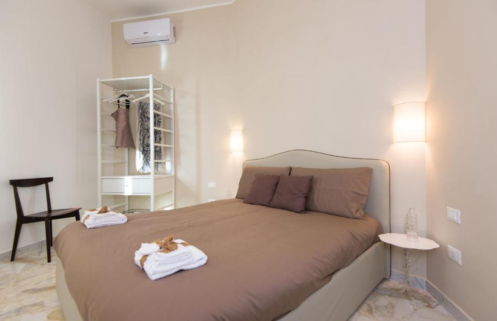 a bedroom with a bed with towels on it at L'ANGOLO DI OLI' in Lecce