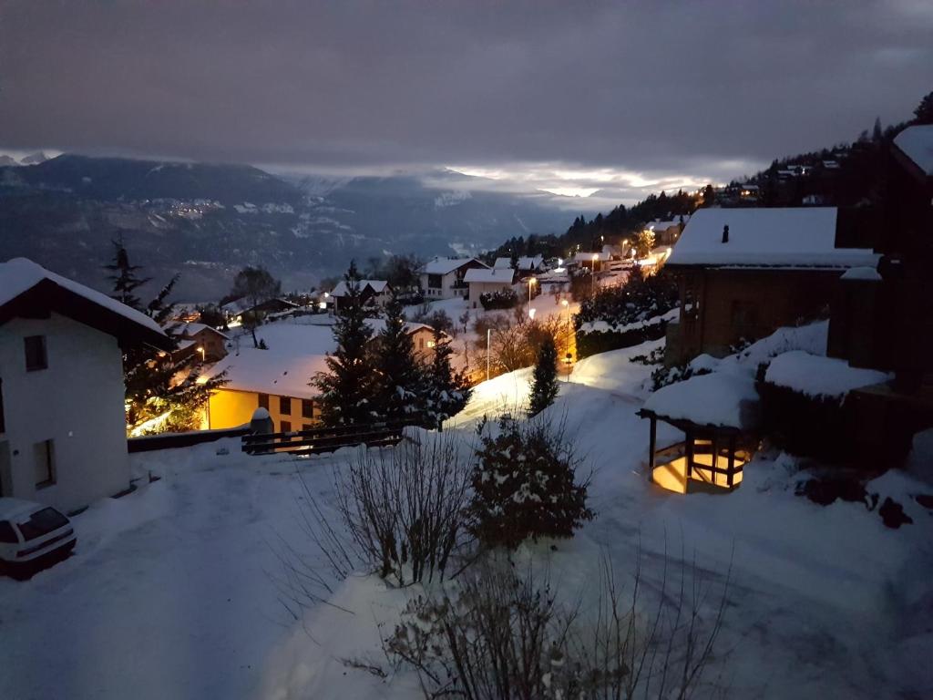 Eine Stadt im Schnee in der Nacht in der Unterkunft Mollens Chalet in Mollens