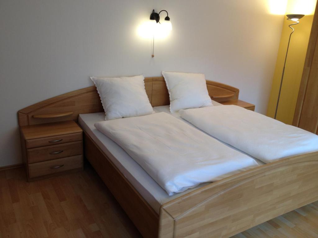 a bed with two pillows on it in a room at Ferienwohnung NEA in Dietersheim