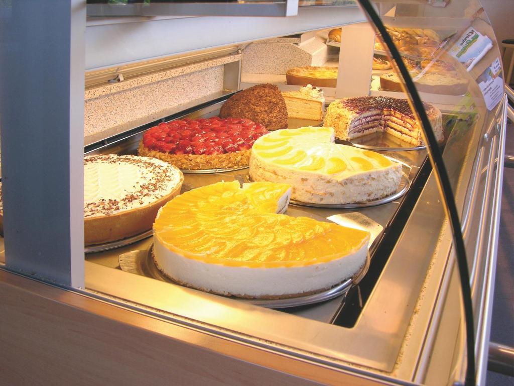 a display case filled with different types of cakes at Cafe Rundblick in Baiersbronn