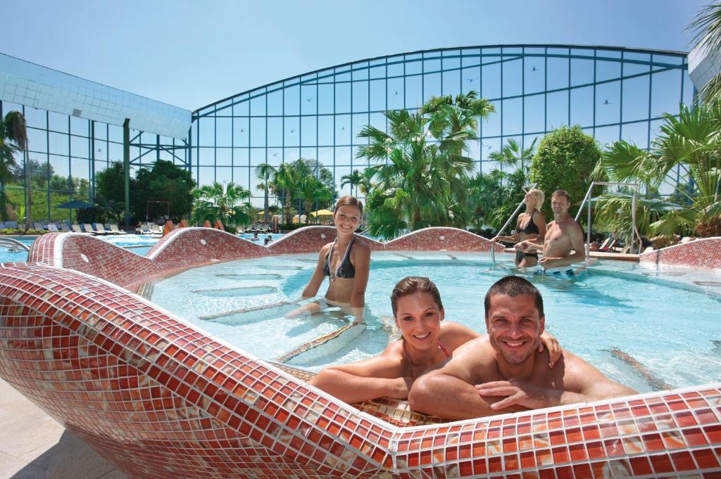 a group of people laying in a swimming pool at Hotel Cebulj in Bad Wörishofen