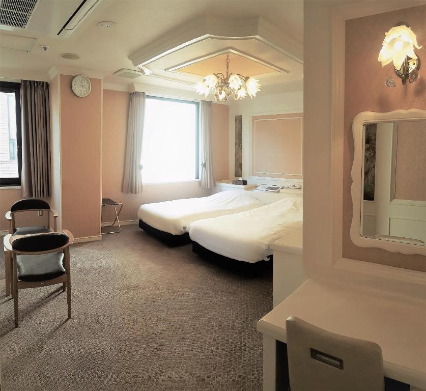 Postel nebo postele na pokoji v ubytování Royal Hotel Shinokubo