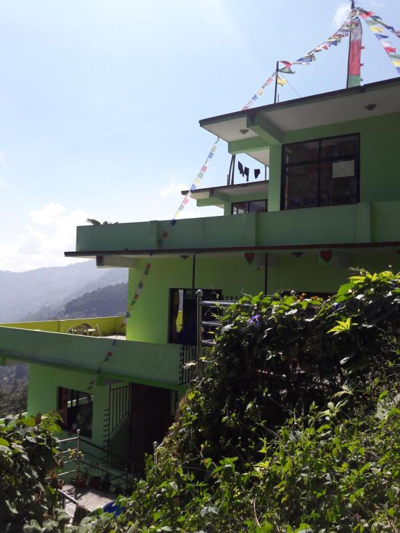a green building on top of a hill at Hotel Greenland in Nagarkot