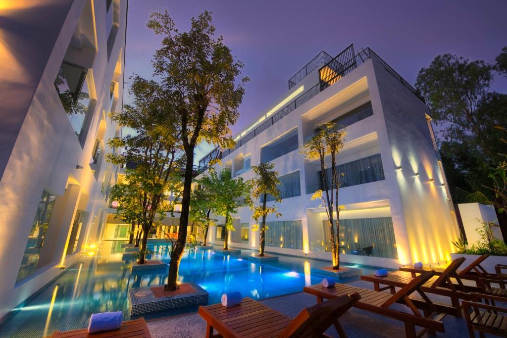 a large building with a swimming pool at night at Chan Boutique in Sihanoukville