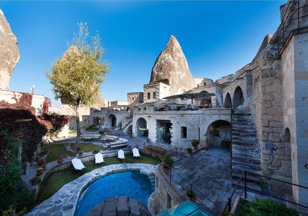 an aerial view of a building with a swimming pool at Anatolian Houses Cave Hotel & SPA in Goreme