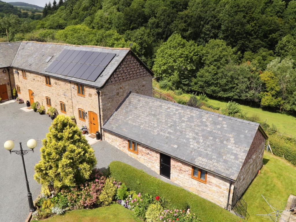 an aerial view of a barn with a solar roof at Little Cow House in Chirk