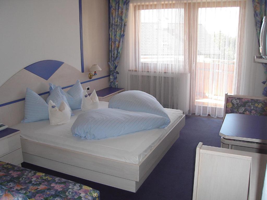 Postel nebo postele na pokoji v ubytování Sporthotel Rasen