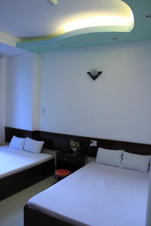 Postel nebo postele na pokoji v ubytování Mai Guest House