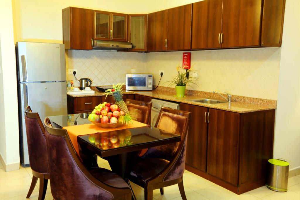 A kitchen or kitchenette at Corp Executive Hotel Doha Suites