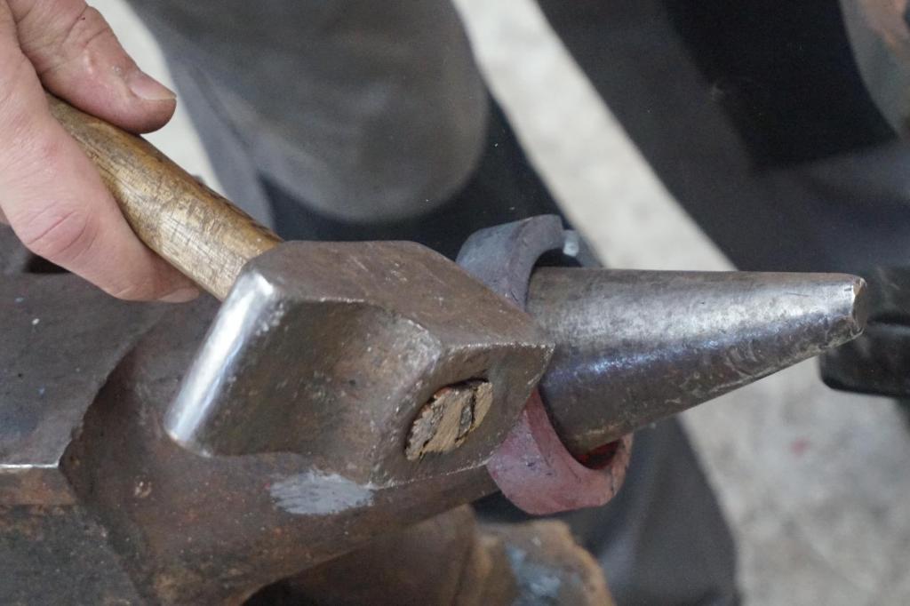 a person is holding a tool on a metal object at l'entresort in Aubusson