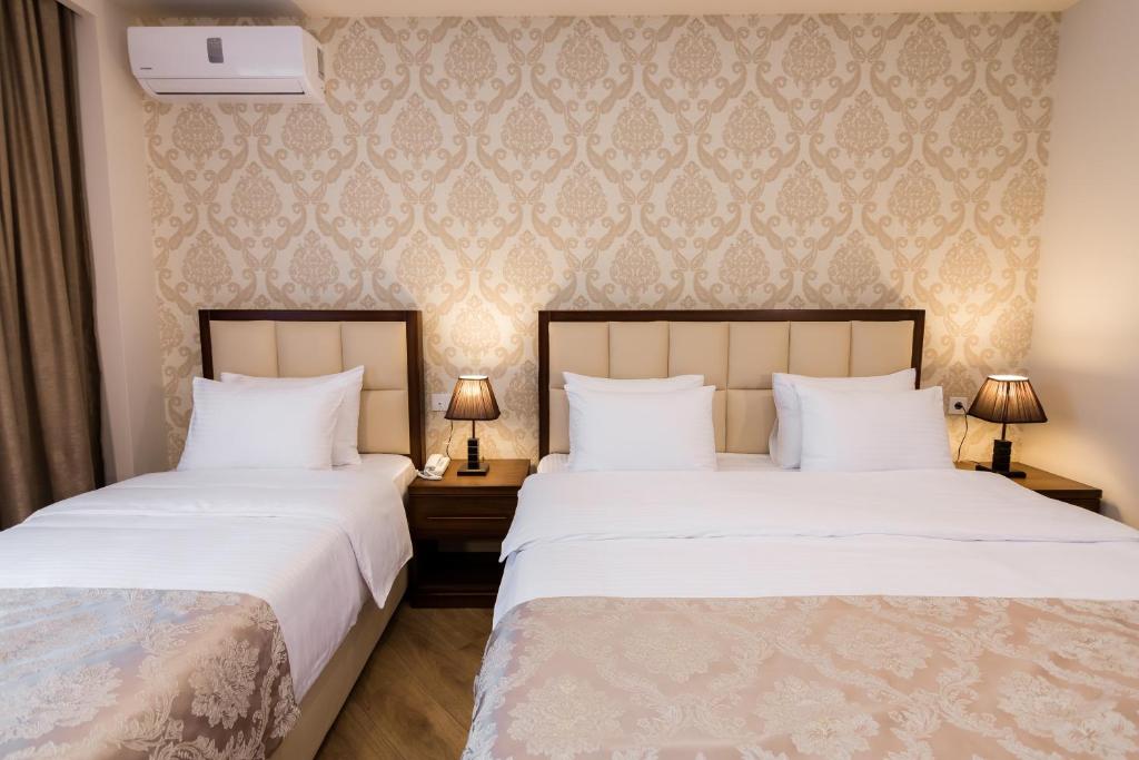 Postel nebo postele na pokoji v ubytování Orchid Boutique Hotel