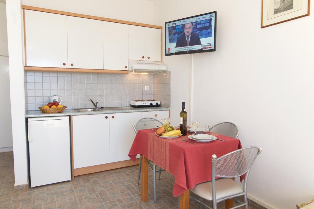a kitchen with a table with a red table cloth on it at Summer Dream in Vlachata