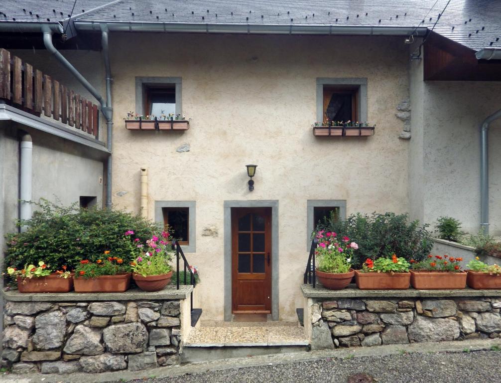 a building with pots of flowers in front of it at Gite, Close To Hautecombe Abbey, Lac du Bourget in Grumeau