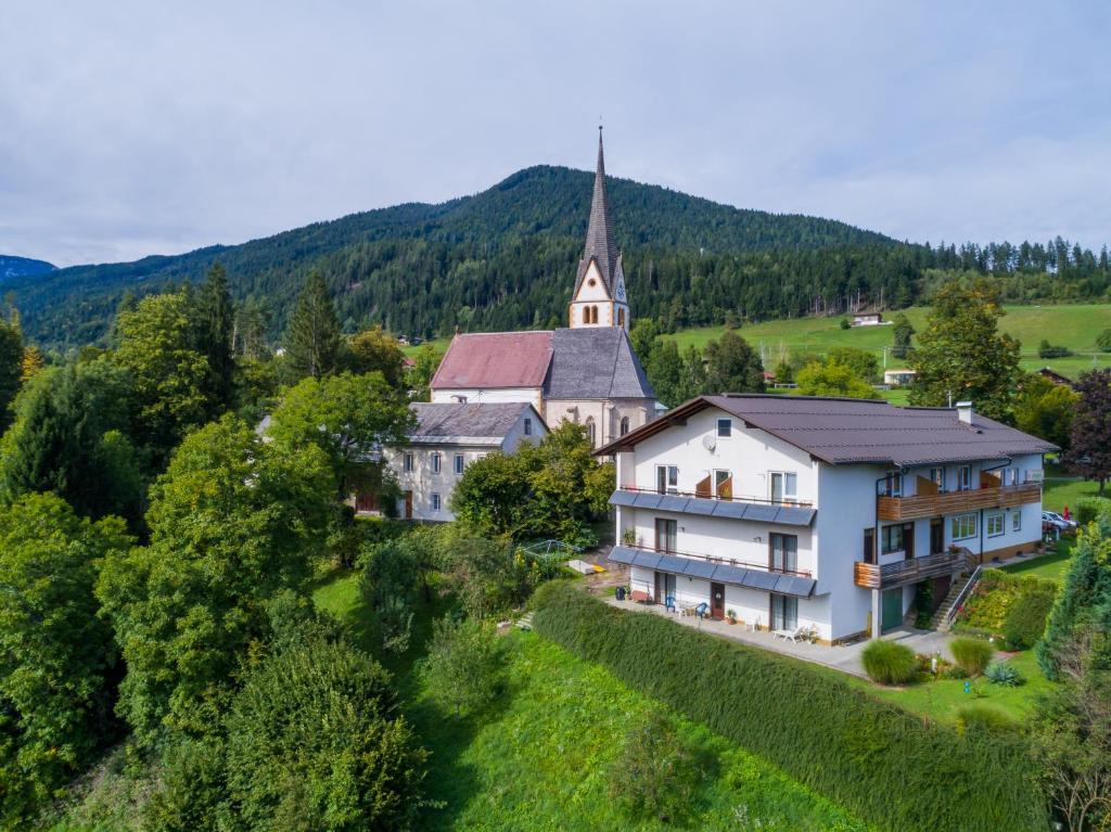 an aerial view of a large white building with a church at Ferienwohnung Andritsch in Sankt Georgen im Gailtal
