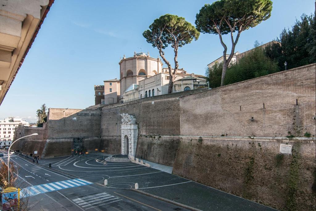 My Bed Vatican Museum في روما: مبنى فوق جدار بجانب شارع