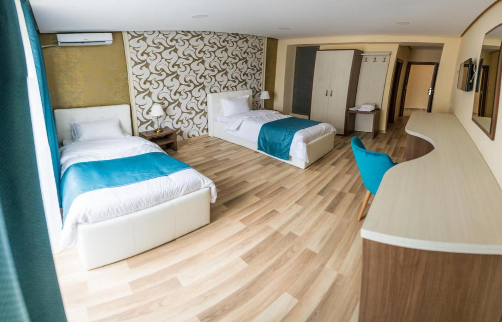 Postel nebo postele na pokoji v ubytování Monopoly Hotel