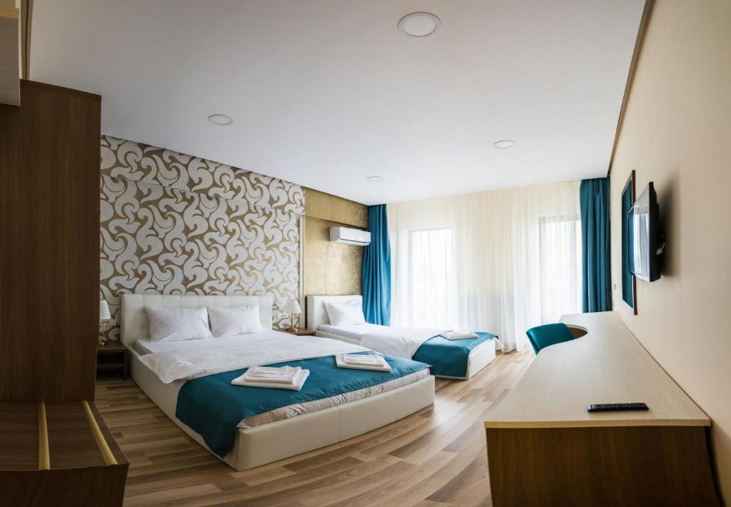 Postel nebo postele na pokoji v ubytování Monopoly Hotel