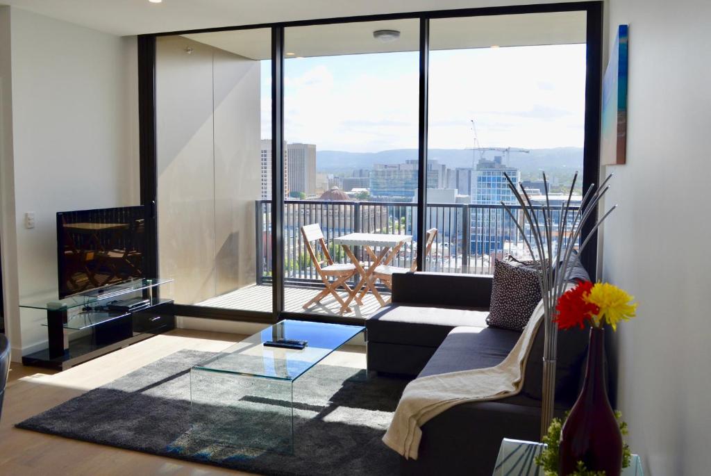 a living room with a couch and a fireplace at Whitmore SQ in Adelaide