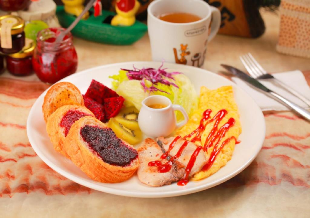 a plate of breakfast food with eggs bread and a cup of tea at Wish Dream in Donggang