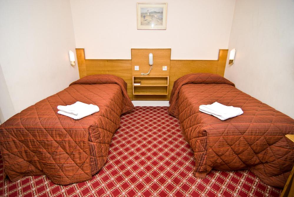 Postel nebo postele na pokoji v ubytování Alexandra Hotel