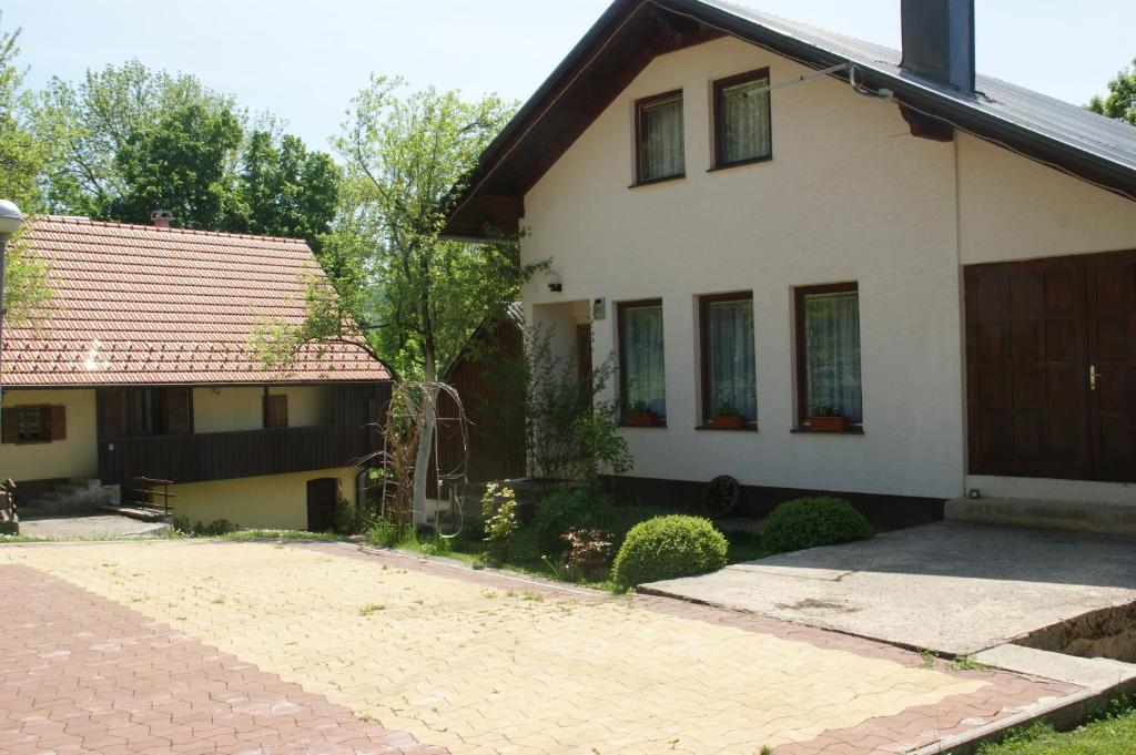 a house with a brick driveway in front of it at Holiday Home Smiljan in Gospić