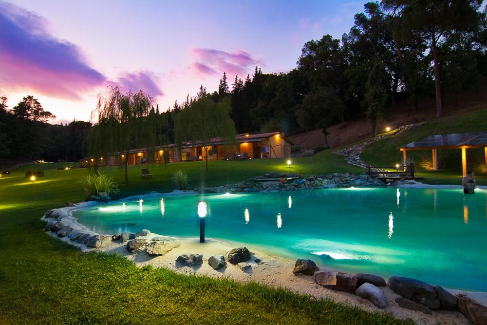 una piscina en un patio trasero por la noche en Lebbiano Residence, en Scandicci